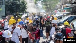 Pengunjuk rasa lari dari kejaran polisi dalam aksi protes menentang kudeta militer di Yangon, Myanmar, 8 Maret 2021. REUTERS / Stringer