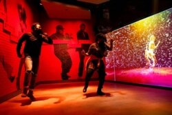 FILE - Armond Carter, left, of Atlanta, and his mother, Latonya Carter, dance together in an exhibit at the National Museum of African American Music, Jan. 30, 2021, in Nashville, Tenn.