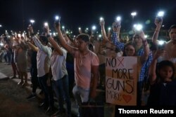 Mourners in Ciudad Juarez, Mexico, take part in a vigil near the border fence between Mexico and the U.S after a mass shooting at a Walmart store in El Paso, Texas, Aug. 3, 2019.