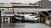 Sebuah pesawat di Bandara Internasional Netaji Subhas Chandra Bose terendam banjir pasca topan Amphan menghantam Kalkuta, India, 21 Mei 2020.