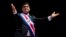 Costa Rica's President Carlos Alvarado greets the public wearing the presidential sash during his swearing-in ceremony, in San Jose, Costa Rica, May 8, 2018. 
