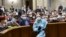 Ukrainian lawmakers wearing face masks to protect against coronavirus attend an extraordinary parliamentary session in Kyiv, Ukraine, March 30, 2020. 