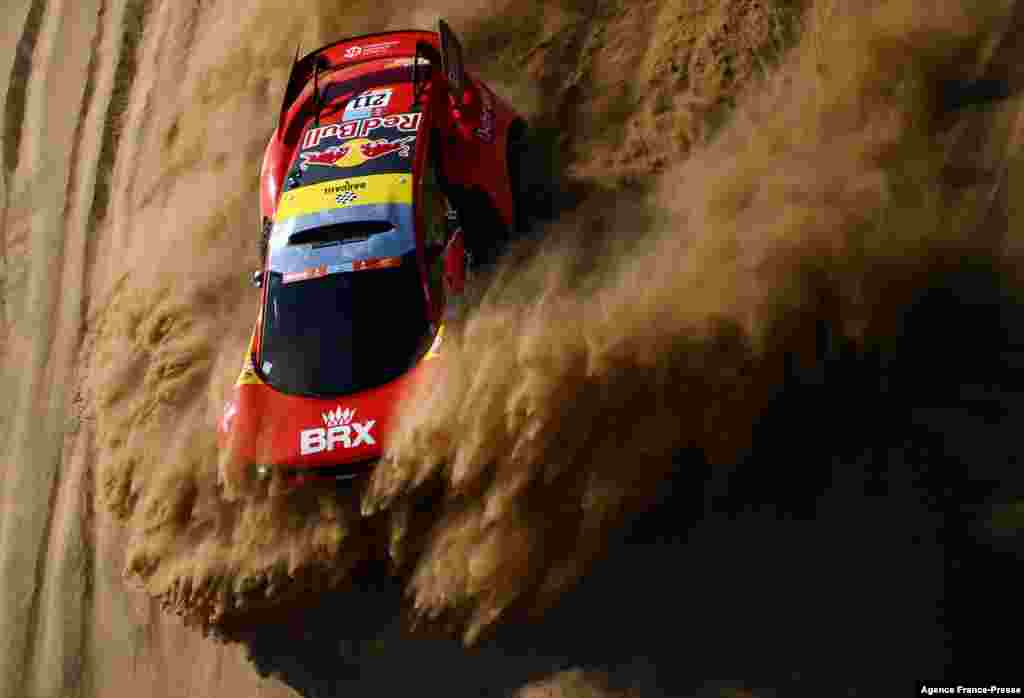 French driver Sebastien Loeb and co-driver Fabian Lurquin of Belgium compete during the Stage 1A of the Dakar Rally 2022 between Jeddah and Hail, in Saudi Arabia, Jan. 1, 2022.