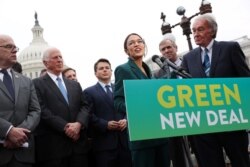 FILE - U.S. Representative Alexandria Ocasio-Cortez (D-NY) and Senator Ed Markey (D-MA) hold a news conference for their proposed Green New Deal to achieve net-zero greenhouse gas emissions in 10 years, at the Capitol in Washington, Feb. 7, 2019.