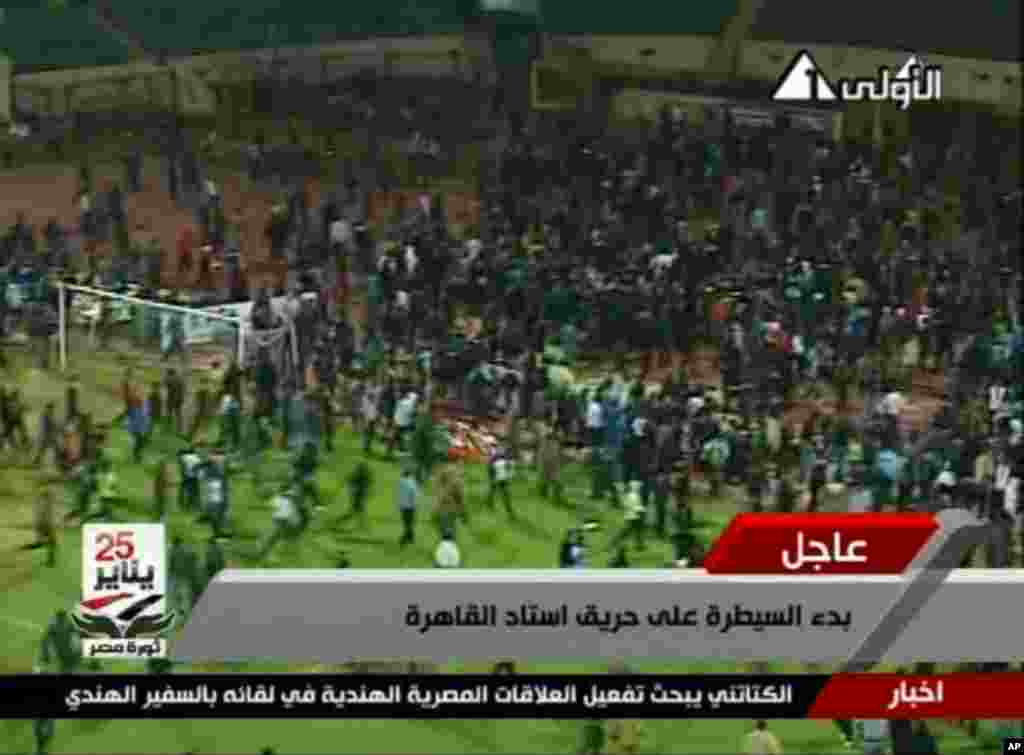 This image from Egypt TV shows fans at a soccer stadium in Port Said, Egypt, February 1, 2012. (AP)