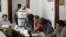 Election officials and party representatives begin the computation of ballot boxes at an electoral institute district council in Mexico City, July 4, 2012. 