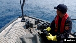 FILE - Indonesian customs officers patrol at a search area for Lion Air flight JT610 in Karawang waters, Indonesia, Nov. 1, 2018. 