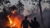 FILE - Firefighters attempt to extinguish a raging forest fire near the town of Melloula in northwestern Tunisia close to the border with Algeria on July 24, 2023.