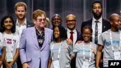 British Prince Harry (2ndL) and sir Elton John (3rdL) pose for a picture during a session about the Elton John Aids Fund on the second day of the Aids2018 conference, in Amsterdam