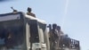FILE - Troops in Eritrean uniforms are seen on top of a truck near the town of Adigrat, Ethiopia, March 14, 2021. Eritrean troops are reported to be withdrawing from Ethiopia's Tigray region on Dec. 30, 2022.