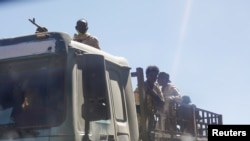 FILE - Troops in Eritrean uniforms are seen on top of a truck near the town of Adigrat, Ethiopia, March 14, 2021.