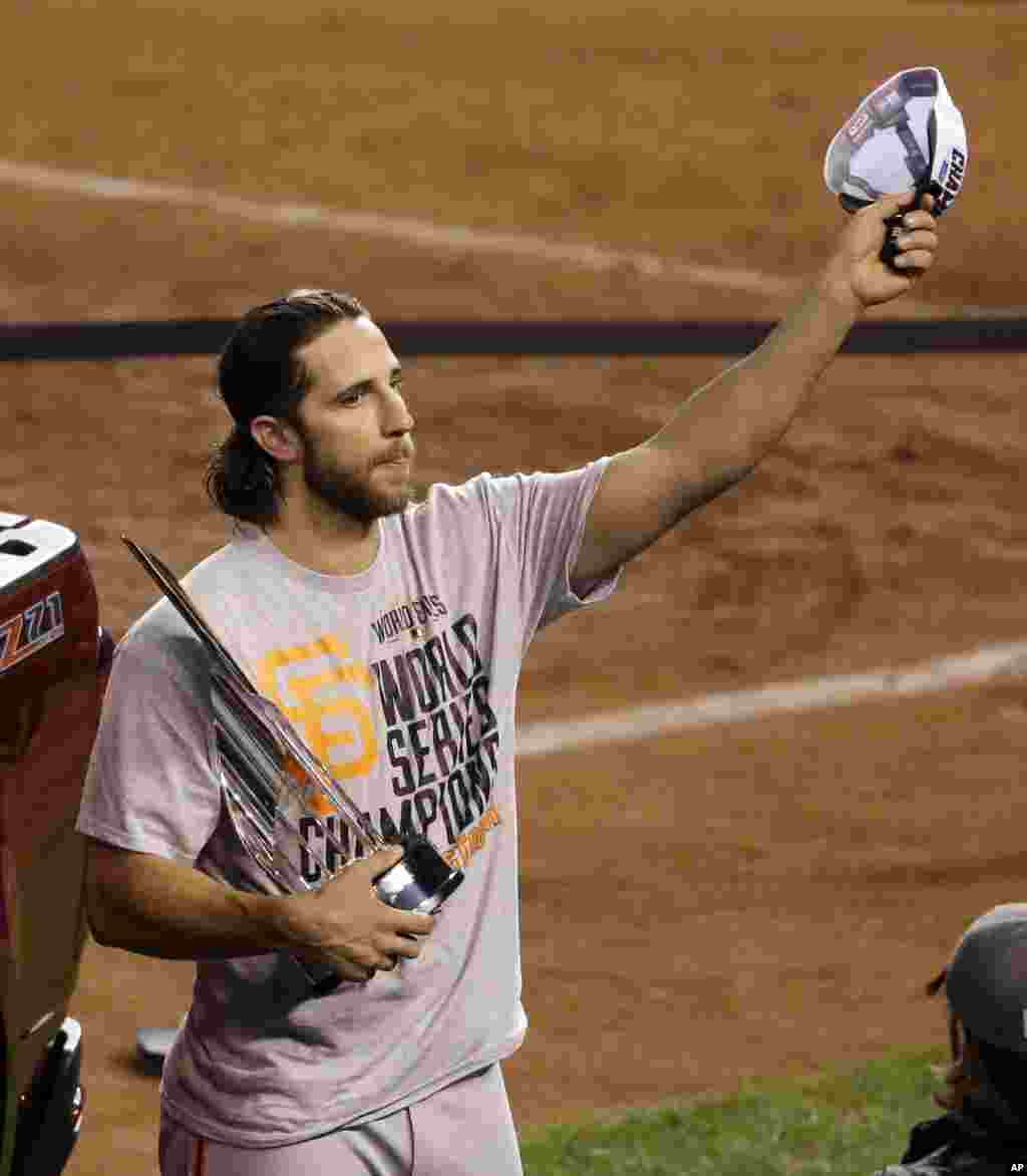 San Francisco Giants pitcher Madison Bumgarner celebrates winning the series and earning the Most Valuable Player trophy after Game 7 of baseball&#39;s World Series against the Kansas City Royals, Kansas City, Missouri, Oct. 29, 2014. 