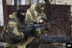 FILE - Russia-backed rebels take positions on the outskirts of Donetsk, eastern Ukraine, April 2, 2015.