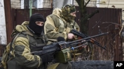 FILE - Russia-backed rebels take positions on the outskirts of Donetsk, eastern Ukraine, April 2, 2015. 