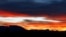 The tower of the Allerheiligen church in Reitham and the mountains of the lake Tegernsee area are silhouetted against the dusk sky in Warngau, Germany.