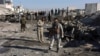 Afghan security personnel gather at the site of a suicide attack at a police compound in Maiwand district of Kandahar province on December 22, 2017.