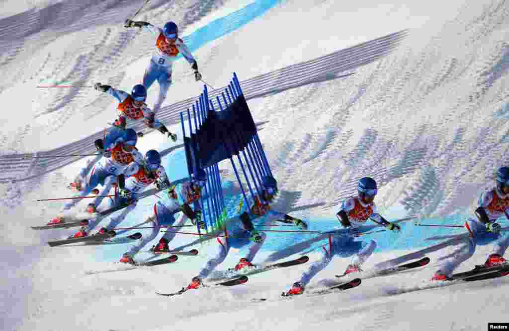 This multiple exposure image shows Austria's Benjamin Raich clearing a gate during the second run of the men's alpine skiing giant slalom event at the 2014 Sochi Winter Olympics, Rosa Khutor Alpine Center, Feb. 19, 2014.
