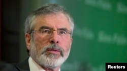 FILE - Sinn Fein's Gerry Adams holds a news conference following his release from police detention, in Belfast, May 4, 2014.
