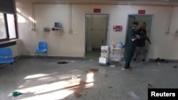 People walk inside the Children's Hospital after an explosion near the Sardar Mohammad Daud Khan National Military Hospital in central Kabul, Afghanistan Nov. 2, 2021.