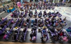 Penumpang duduk di ruang tunggu di Stasiun Kereta Hua Lamphong, Bangkok, Thailand, Jumat, 9 April 2021.