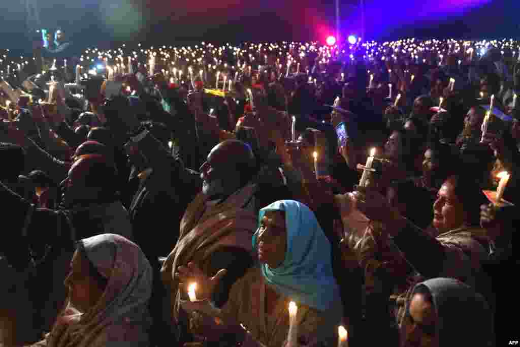 Pakistani Christians attend the candle light Carol service during the Christmas celebration in Lahore.