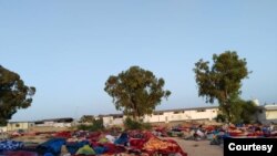 FILE - After a detention center was bombed, remaining structures appeared unstable and, five days later, migrants were still sleeping outdoors in Tripoli, Libya, July 7, 2019. 