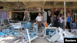 Residents stand among debris at one of the scenes of car bomb attacks that struck Baghdad July 19, 2014. A series of car bombs struck Baghdad on Saturday, killing 22 people, police and medics said. Car bombs exploded in three mainly Shi'ite districts, kil