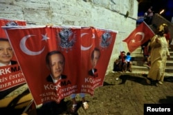 FILE - A street vendor sells banners with a photo of Turkish President Tayyip Erdogan in Uskudar district in Istanbul, Turkey, July 21, 2016.