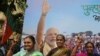 Supporters of India's ruling Bharatiya Janata flash victory signs as they celebrate outside their party office in Mumbai, India, Oct. 24, 2019.