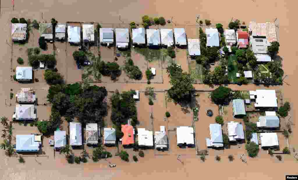 Houses are surrounded by floodwaters brought on by Cyclone Debbie at Depot Hill in Rockhampton, Australia.