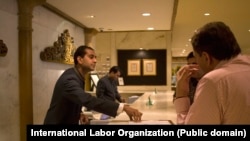 At the reception desk of the Taj Palace hotel of New Delhi, India, an employee interacts with guests.