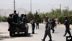 Security personnel arrive at the site of an attack in the Afghan Interior Ministry in Kabul, Afghanistan, Wednesday, May 30, 2018. 