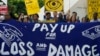 FILE - Activists participate in a demonstration for the loss and damage fund at the COP28 U.N. Climate Summit, Dec. 6, 2023, in Dubai, United Arab Emirates.