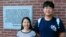 Chinese graduate students Zhaojin Li, left, and Pengfei Liu, pose in front of the entrance to the Robert Larner College of Medicine at the University of Vermont in Burlington, Vermont, Aug. 16, 2019.