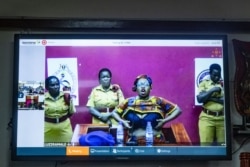 Jailed activist Stella Nyanzi appears by video link as she protests following her sentencing after being charged guilty of cyber harassment against Uganda’s president, in Kampala, Aug. 2, 2019.