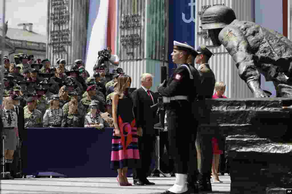 U.S President Donald Trump and First Lady Melania Trump stand in front of the Warsaw Uprising Monument at Krasinski Square, July 6, 2017.