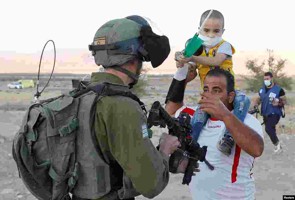 A Palestinian man argues with an Israeli soldier during a protest against Israel&#39;s plan to annex parts of the occupied West Bank, in Jordan Valley, June 24, 2020.