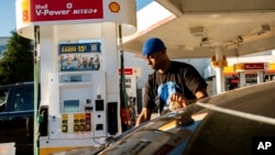 FILE - A motorist fills up his vehicle at a gas station in San Francisco, California, Nov. 22, 2021. 