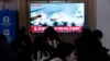 A TV screen shows a file image of a North Korean military exercise during a news program at the Seoul Railway Station in Seoul, South Korea, on Jan. 6, 2024, after North Korea fired over 60 artillery rounds near Yeonpyeong Island.