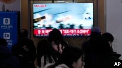 A TV screen shows a file image of a North Korean military exercise during a news program at the Seoul Railway Station in Seoul, South Korea, on Jan. 6, 2024, after North Korea fired over 60 artillery rounds near Yeonpyeong Island.