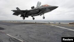 FILE - A Lockheed Martin F-35B Lightning II Joint Strike fighter jet touches down on the amphibious assault ship USS Wasp in the Indo-Asian-Pacific region in East China Sea, March 5, 2018.