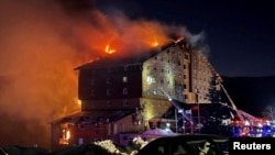 Firefighters work to extinguish a fire at a hotel in the ski resort of Kartalkaya in Bolu, Turkey, Jan. 21, 2025. (Ihlas News Agency (IHA) via Reuters) 