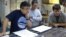 Researchers, from left, Yuki Morono, Laurent Toffin and Steven D’Hondt work aboard the research drillship JOIDES Resolution with sediment cores gathered from beneath the sea floor under the Pacific Ocean in this undated photo released July 28, 2020.