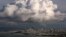 A large cloud gathers over the skyline of San Francisco, California, Dec. 12, 2014. While the Pacific Northwest is expected to have a mild winter, California's forecast is unsure.