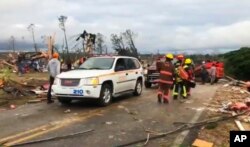 Emergency responders work in the scene amid debris in Lee County, Ala., after what appeared to be a tornado struck in the area Sunday, March 3, 2019.