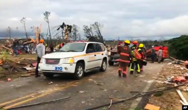 Emergency responders work in the scene amid debris in Lee County, Ala., after what appeared to be a tornado struck in the area Sunday, March 3, 2019.