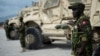 (FILE) A Kenyan member of the Multinational Security Support Mission stands next to a Maxxpro Mine Resistant Ambush Protected Vehicle in Port Au Prince, Haiti on September 05, 2024.