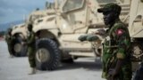 (FILE) A Kenyan member of the Multinational Security Support Mission stands next to a Maxxpro Mine Resistant Ambush Protected Vehicle in Port Au Prince, Haiti on September 05, 2024.