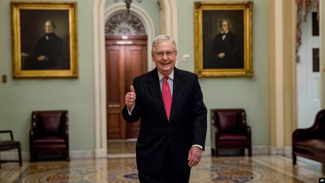 Senate Majority Leader Mitch McConnell of Ky. gives a thumbs up as he arrives on Capitol Hill, March 25, 2020, in Washington. 