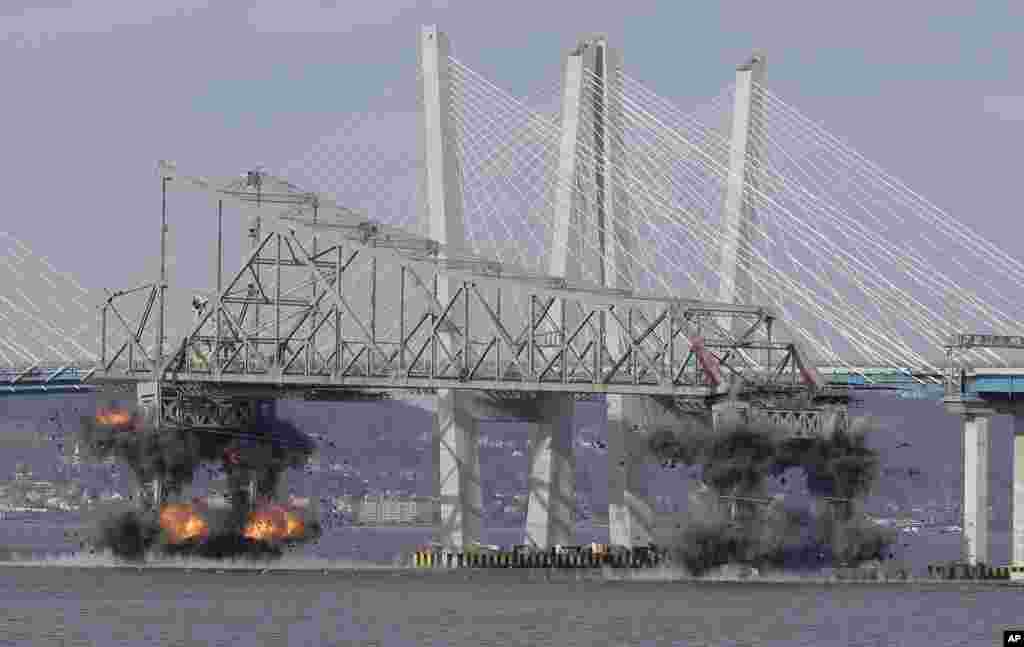 A section of the old Tappan Zee Bridge is brought down with explosives in this view from Tarrytown, New York.